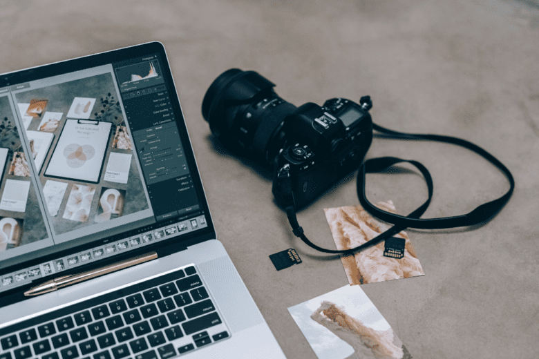 Camera next to a laptop displaying photography software, used for school picture day preparation