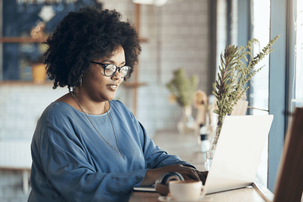 Woman working on a laptop, highlighting digital marketing strategies for school photography growth.