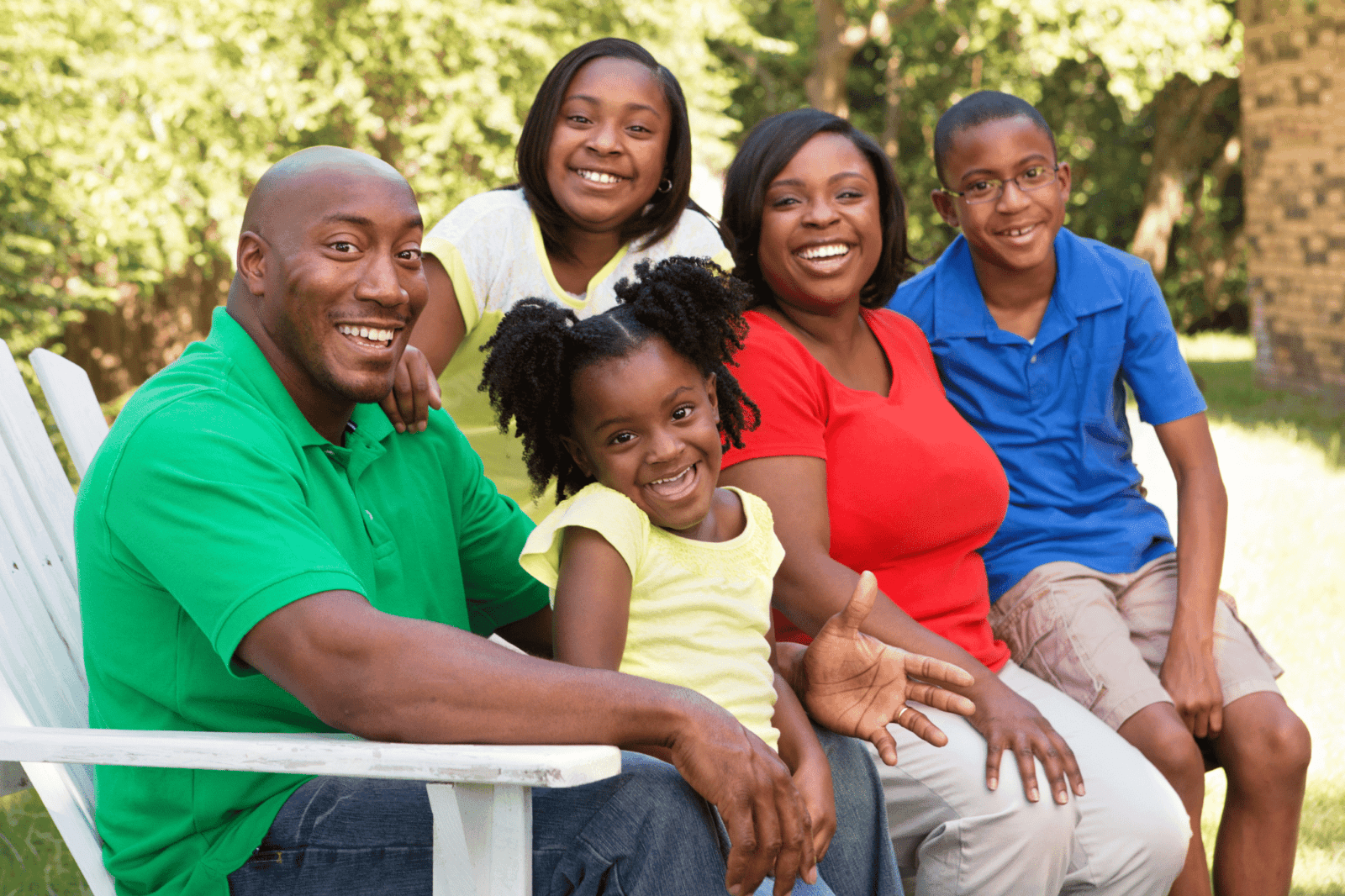 A family poses for a photo outside