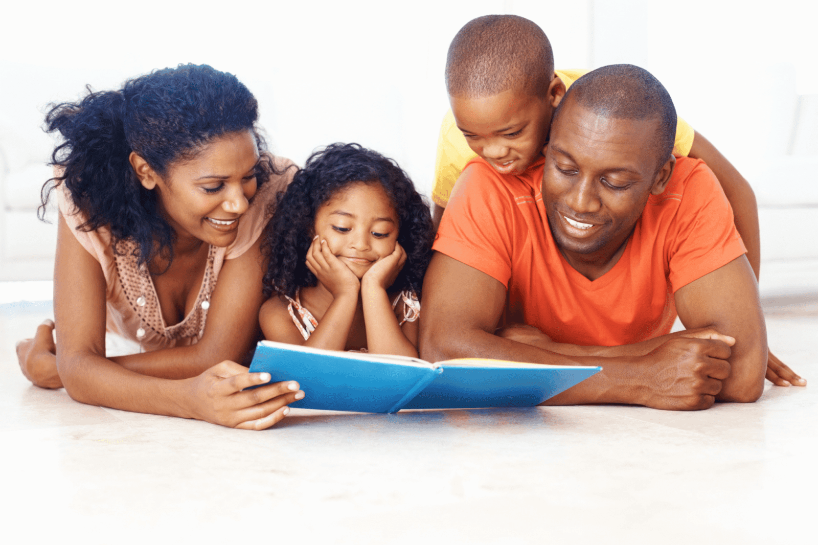 A candid interaction pose of a family reading a book together