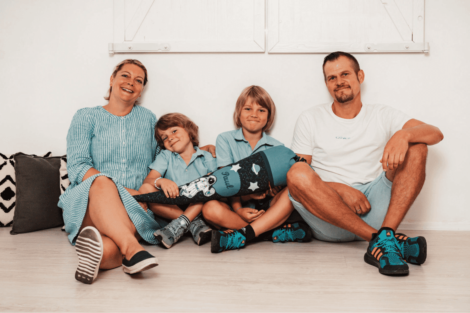 Children smiling comfortably with their parents in a family portrait