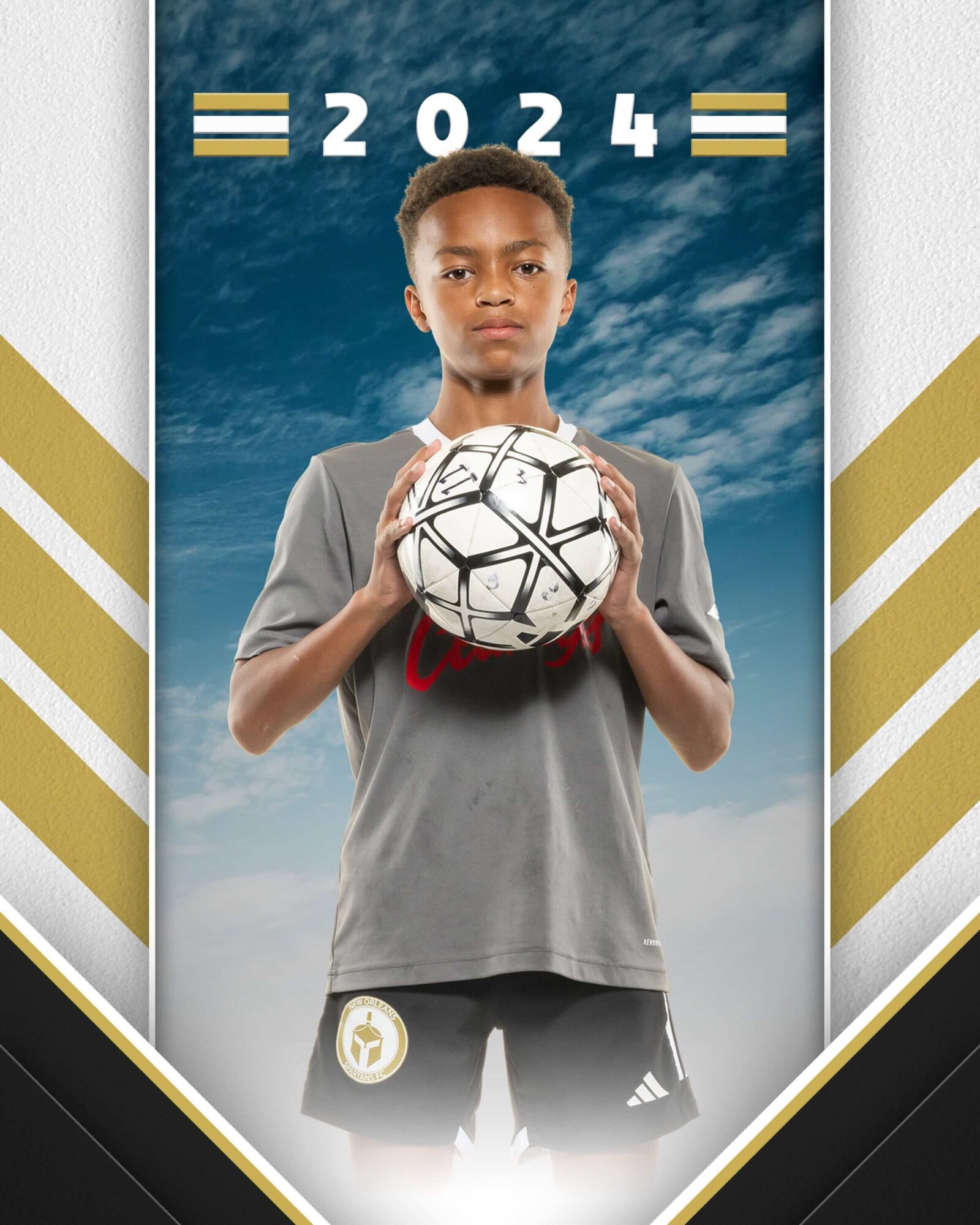 A youth soccer player poses with the soccer ball in a headshot