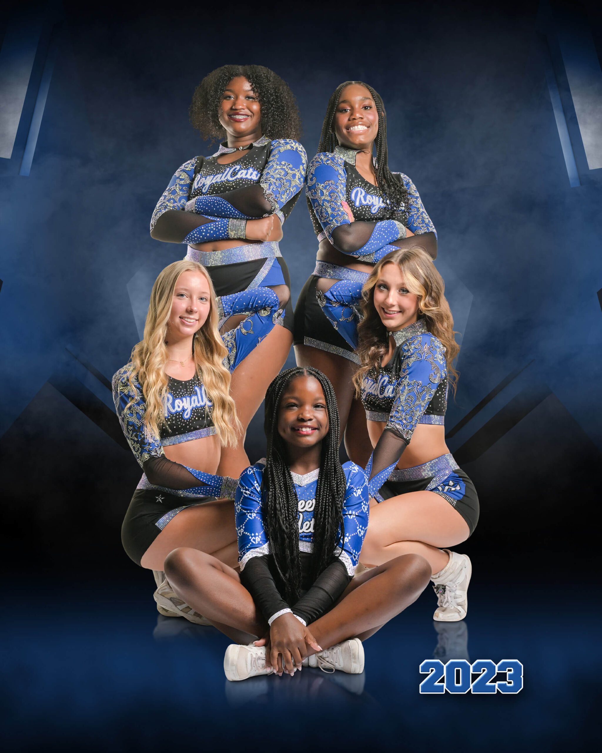 Group of five cheerleaders poses together