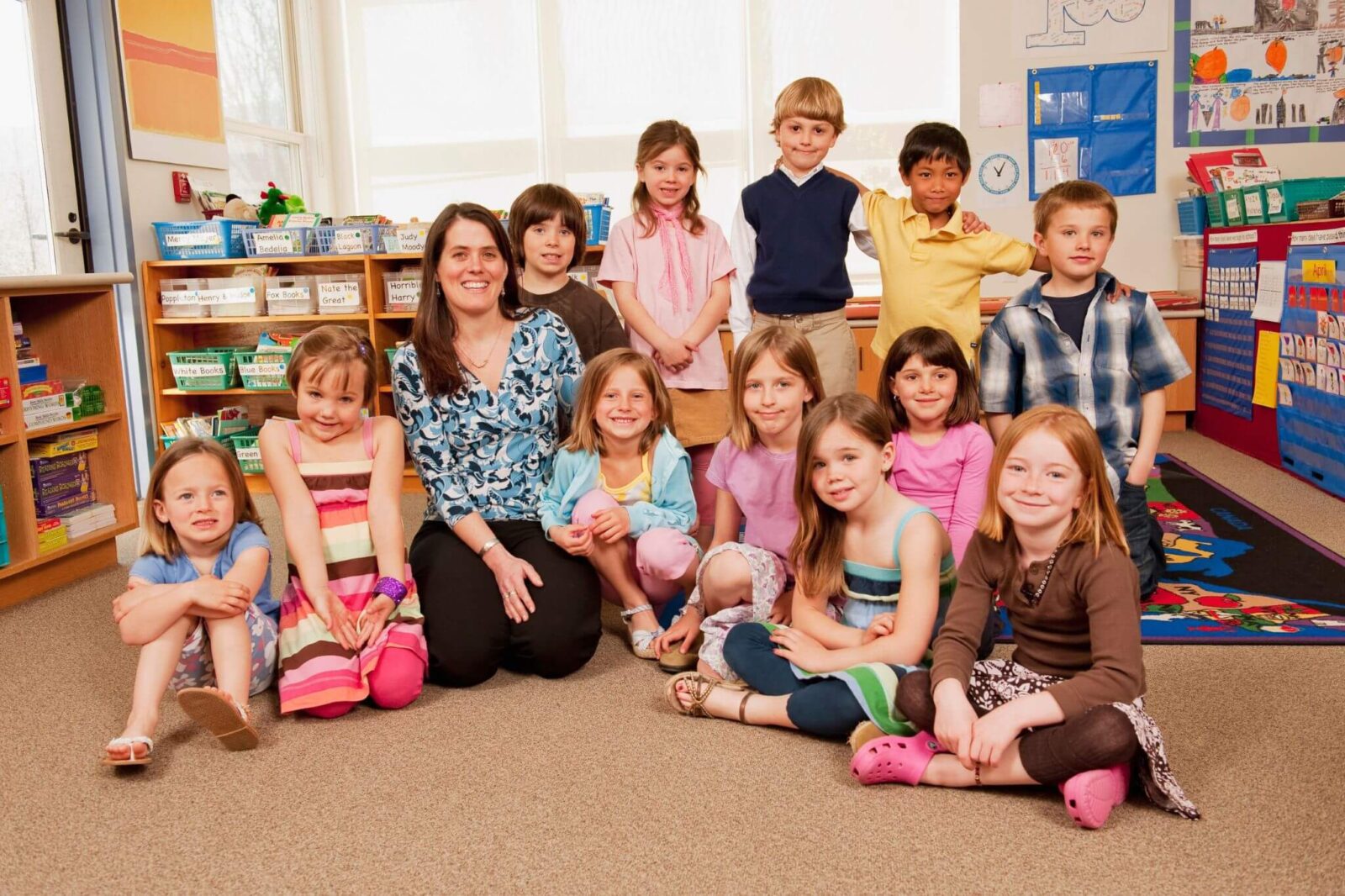 A kindergarten class picture with their teacher in the classroom