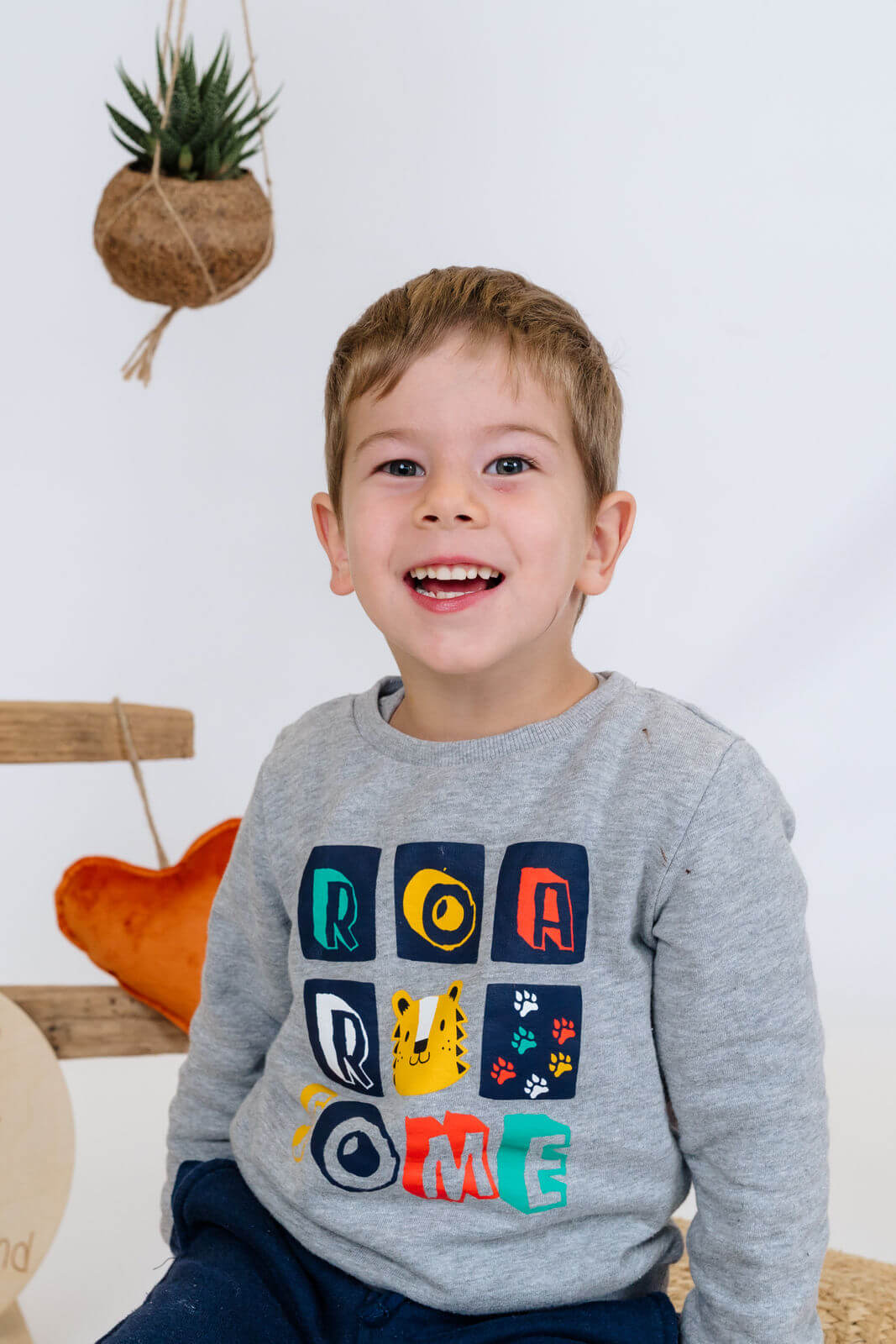 Young boy in preschool or kindergarten smiles for his school picture