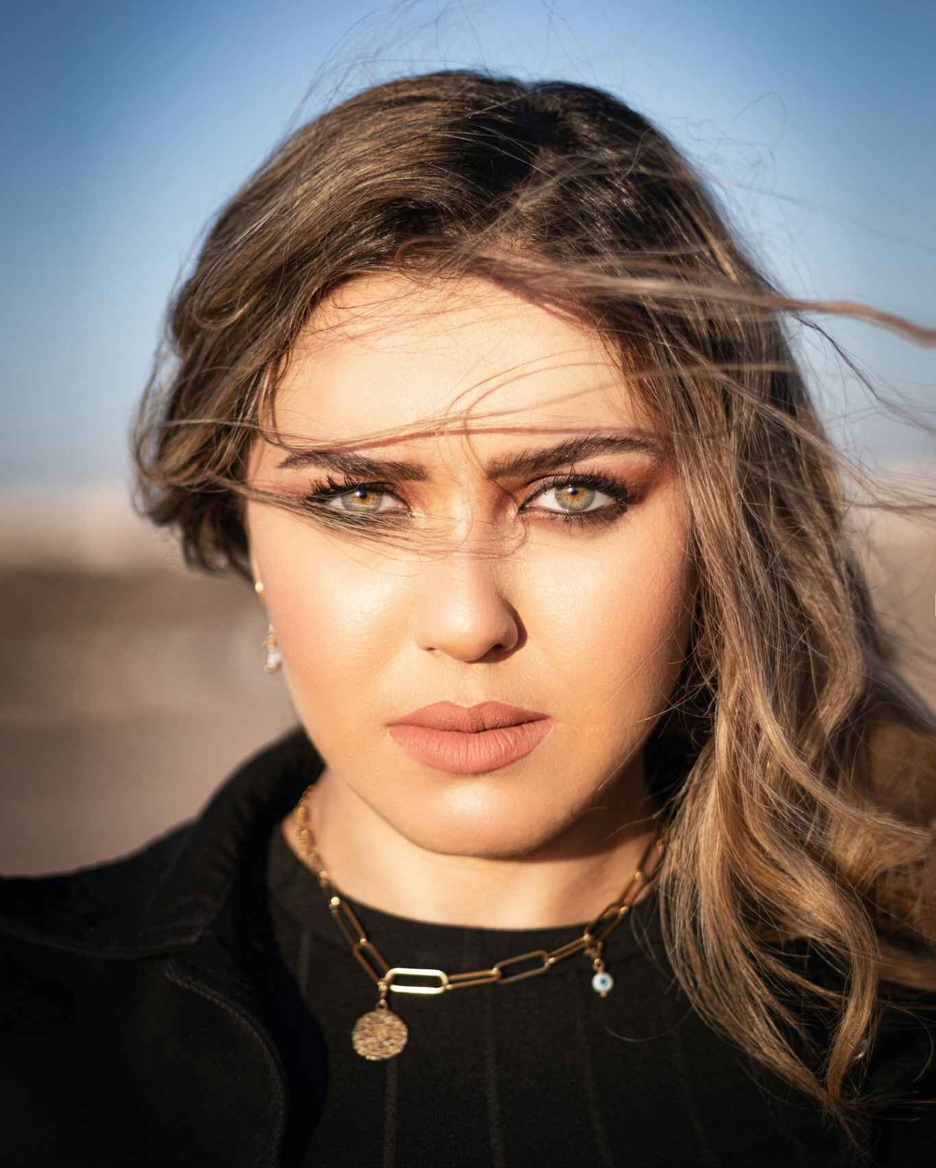 A woman poses for a portrait photograph