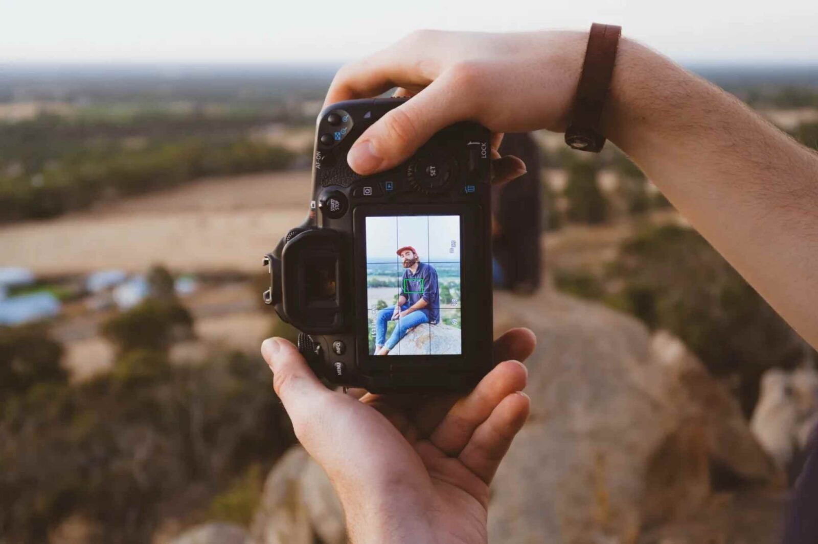 A person takes a portrait photograph outside showing skills