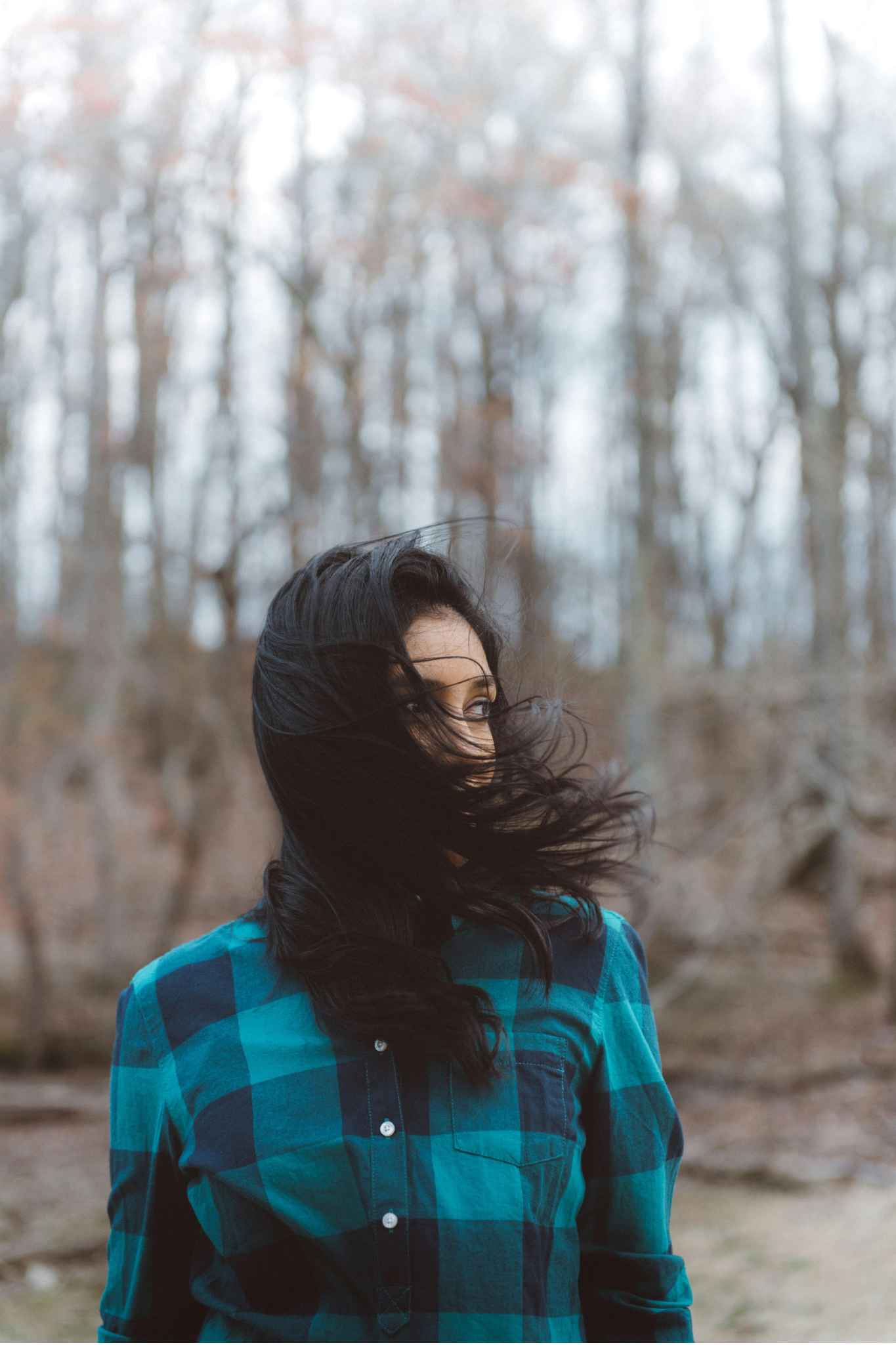 An outdoor portrait of a woman on a cloudy and windy day