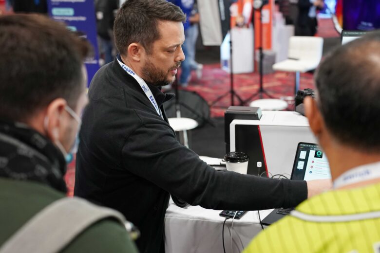 A GotPhoto team member gives a demo of the Entagged barcode scanning device at SPAC